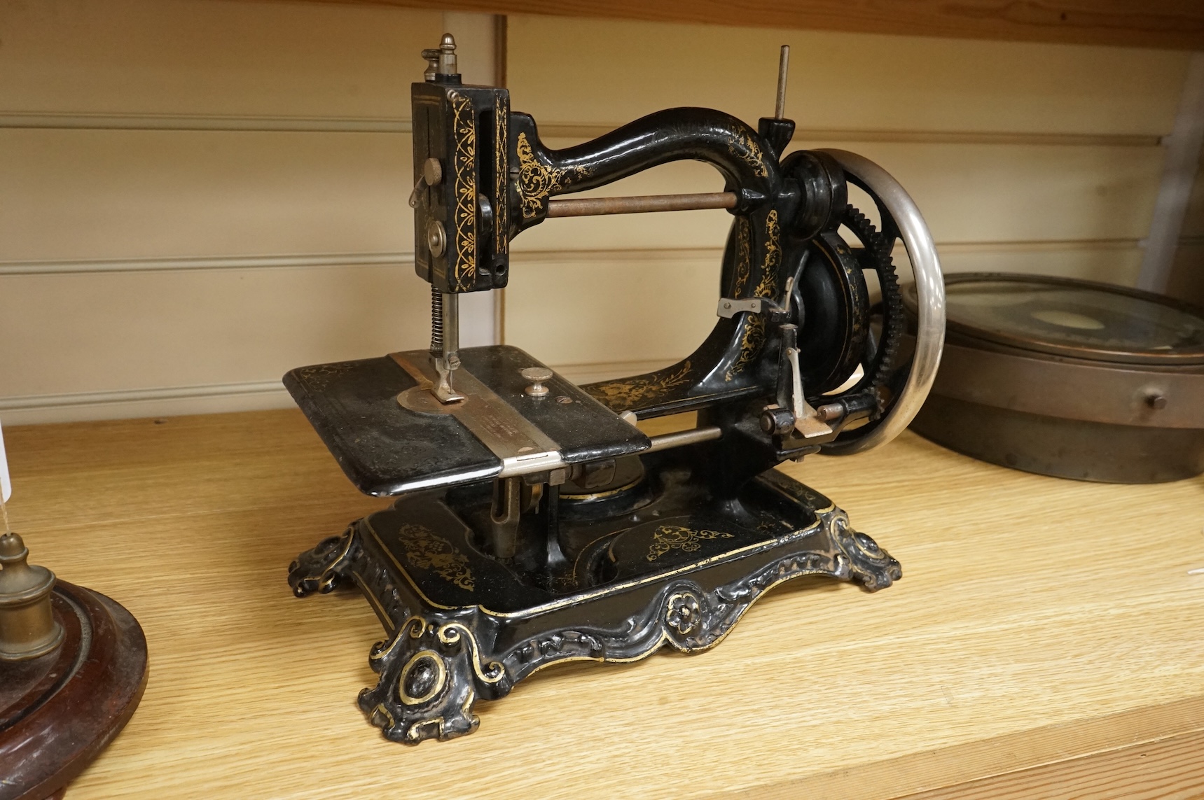 A late 19th century Wanzer sewing machine, in black enamel with gilt decoration.